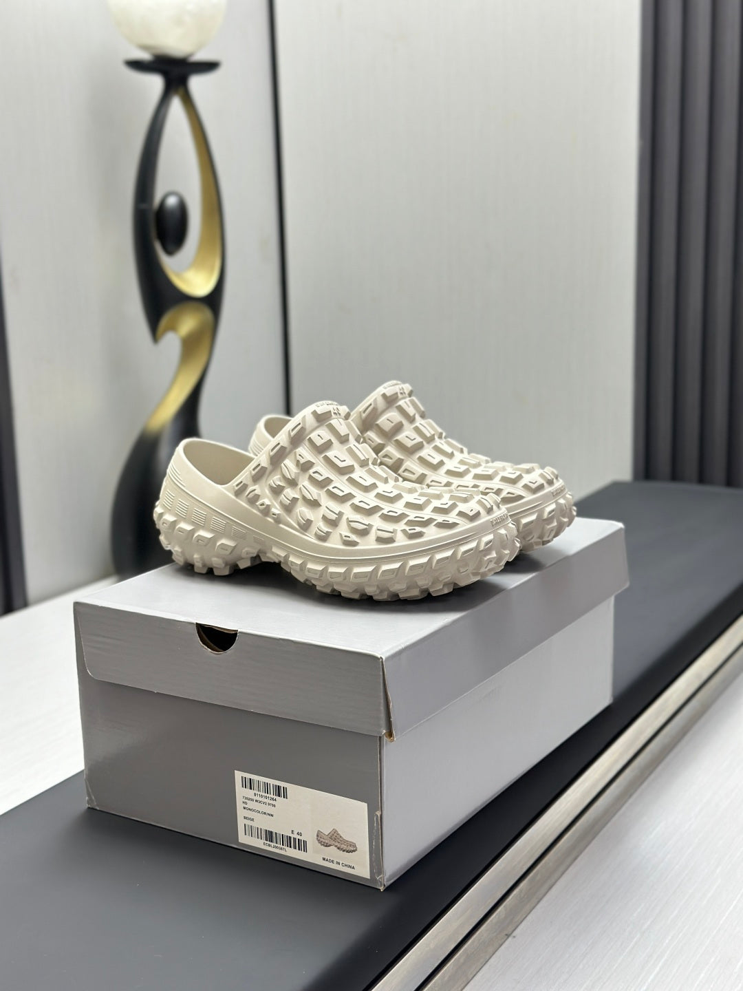 Balenciaga white slip-on sandals, side view with grid-pattern upper and tread sole