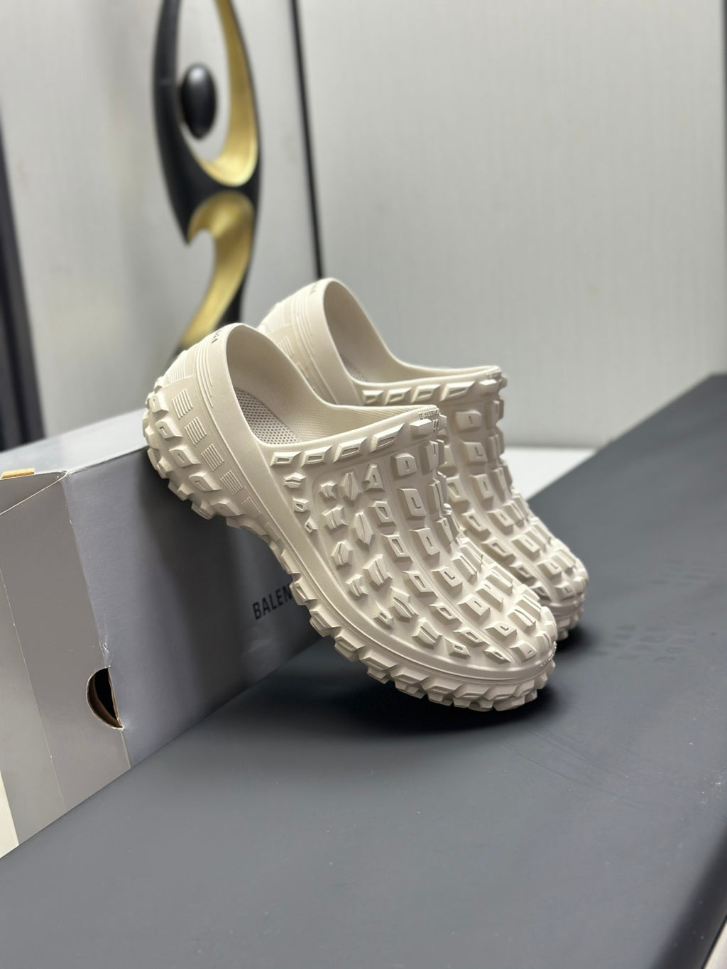 Balenciaga white slip-on sandals, close side view on the box with chunky tread
