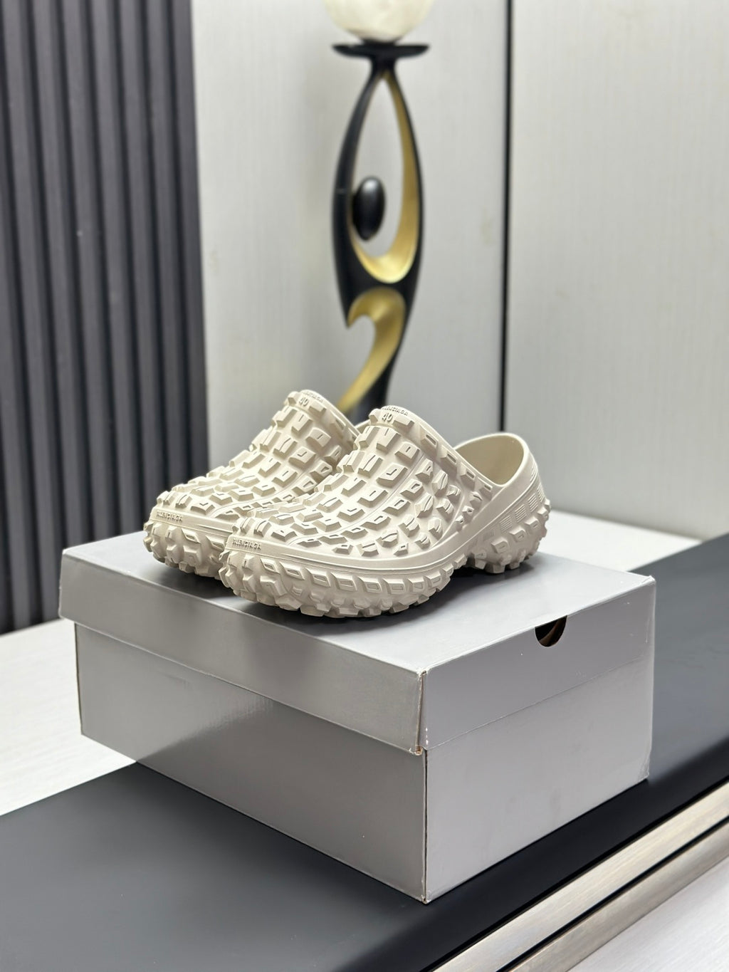 Balenciaga white textured slide sandals on a box, chunky rubber tread sole