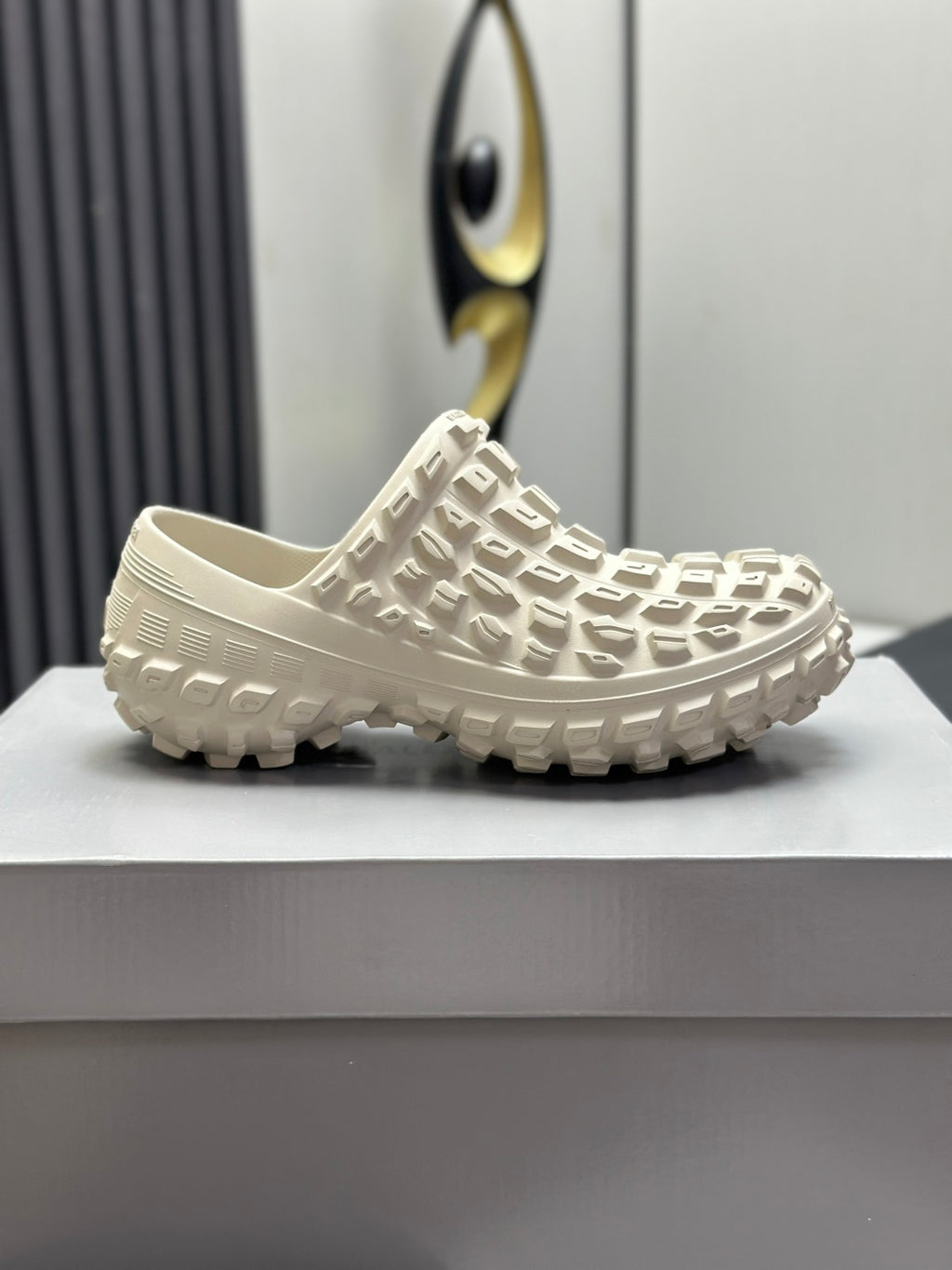 Balenciaga white slide sandals, profile view with textured upper and rugged tread sole