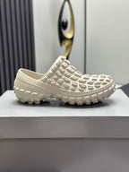 Balenciaga white slide sandals, profile view with textured upper and rugged tread sole