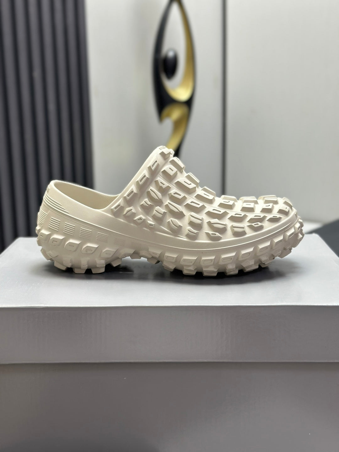 Balenciaga white slide sandals, profile view with textured upper and rugged tread sole