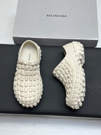 Balenciaga white slide sandals, front and outsole views on a box