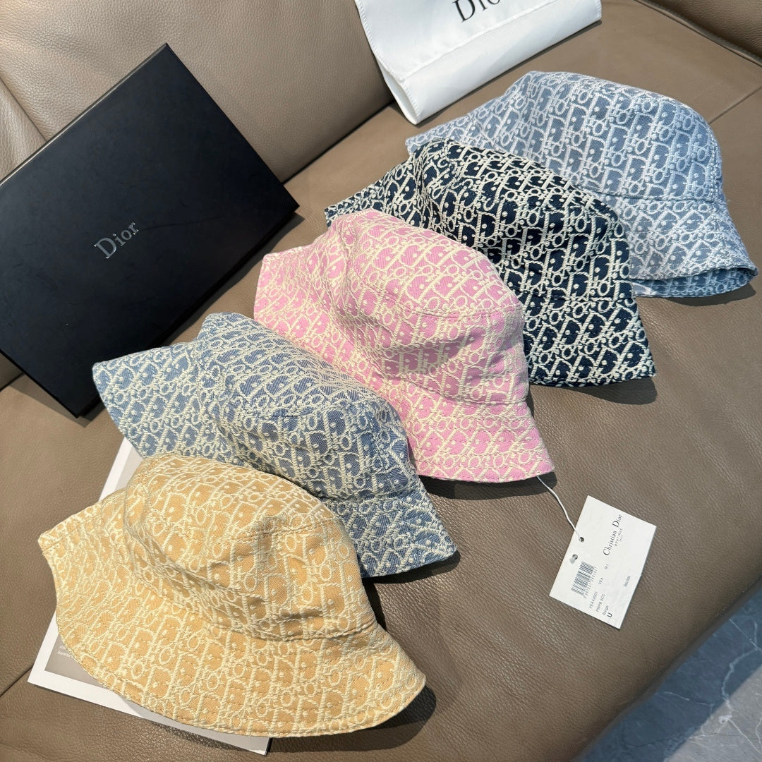 Dior bucket cap assortment: tan, pink, and two blue patterned hats