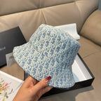 Dior bucket hat in light blue with Dior monogram print, hand-held