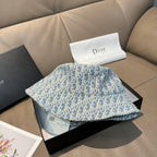 Dior bucket hat in light blue with Dior monogram print, resting on box