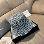 Monogram bucket cap in navy with white Dior-style pattern, wide brim
