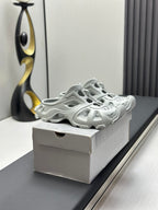 Balenciaga sandals, light gray, side view with sculpted footbed and cutout details