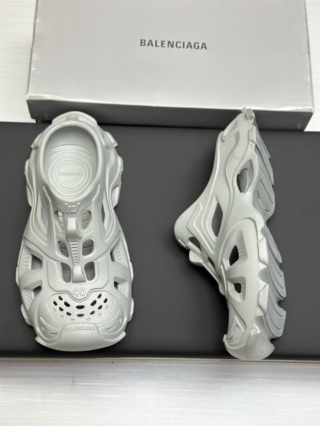 Balenciaga sandals, light gray, back view pair on box with textured sole