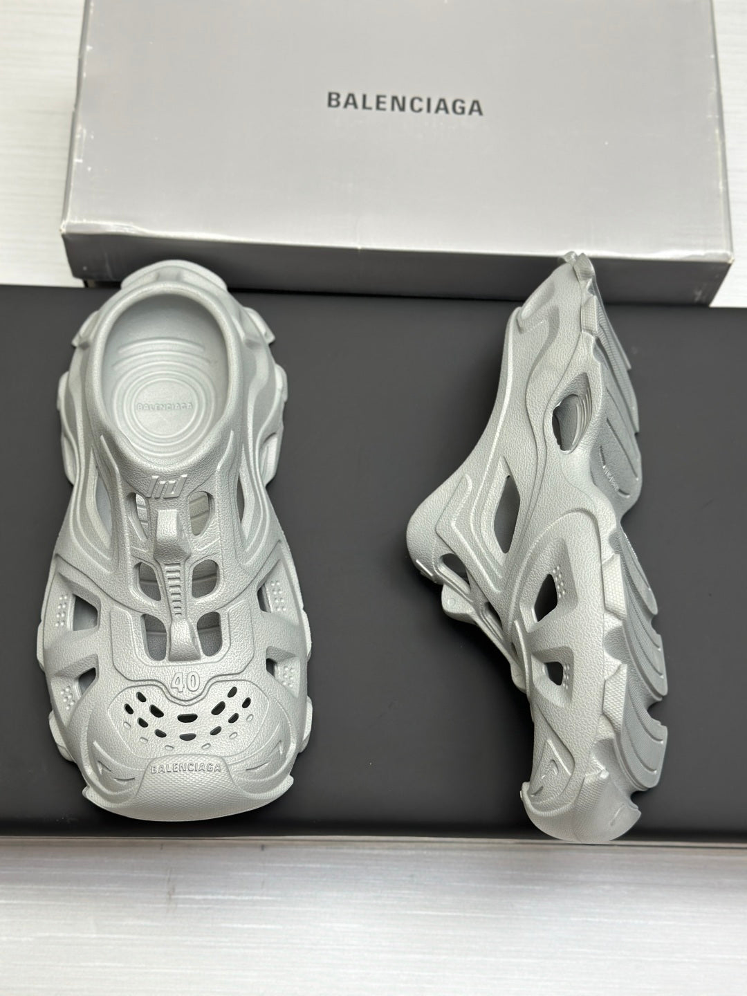 Balenciaga sandals, light gray, back view pair on box with textured sole