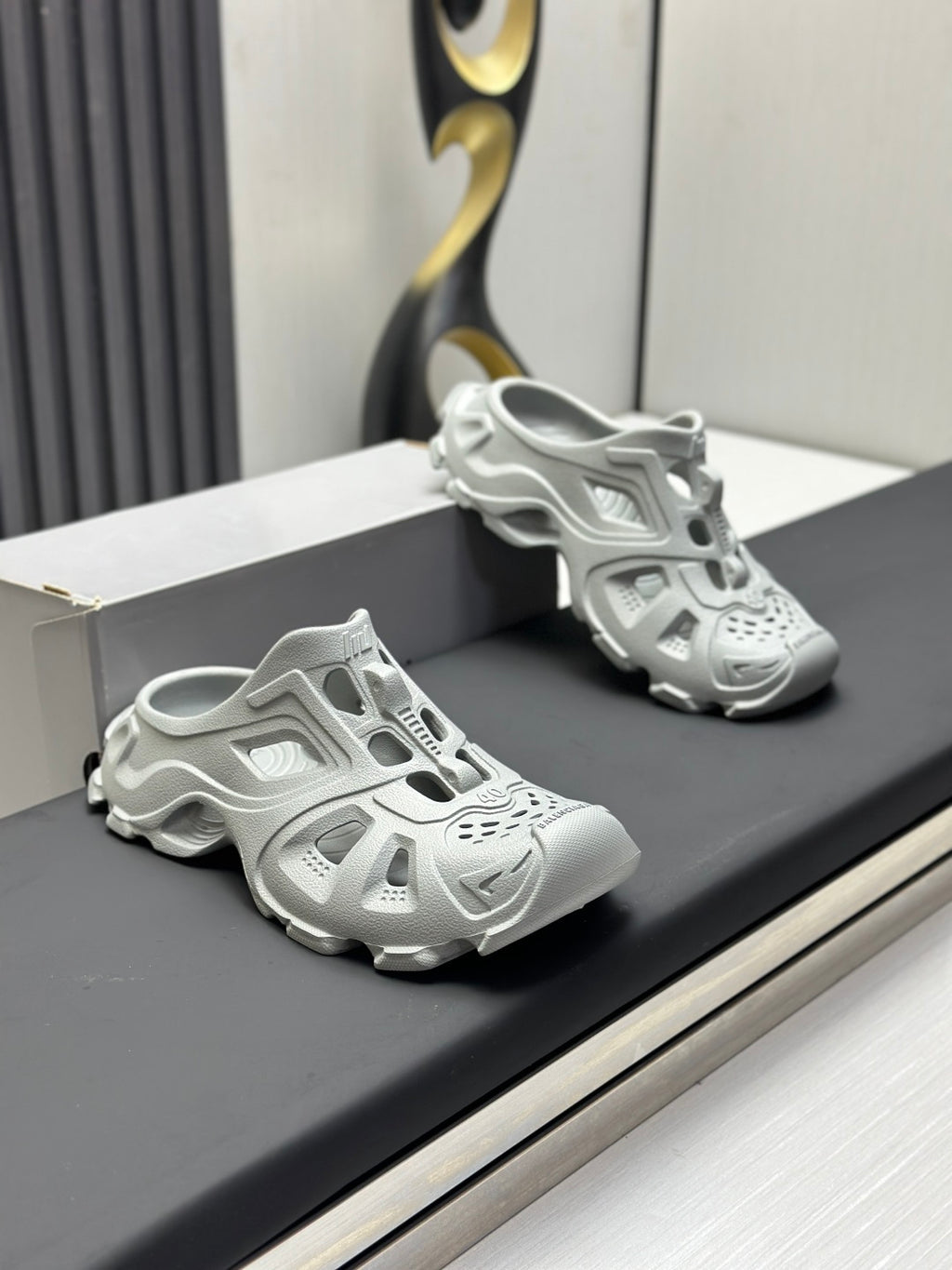 Balenciaga sandals, light gray, front view pair on a box with perforations and straps