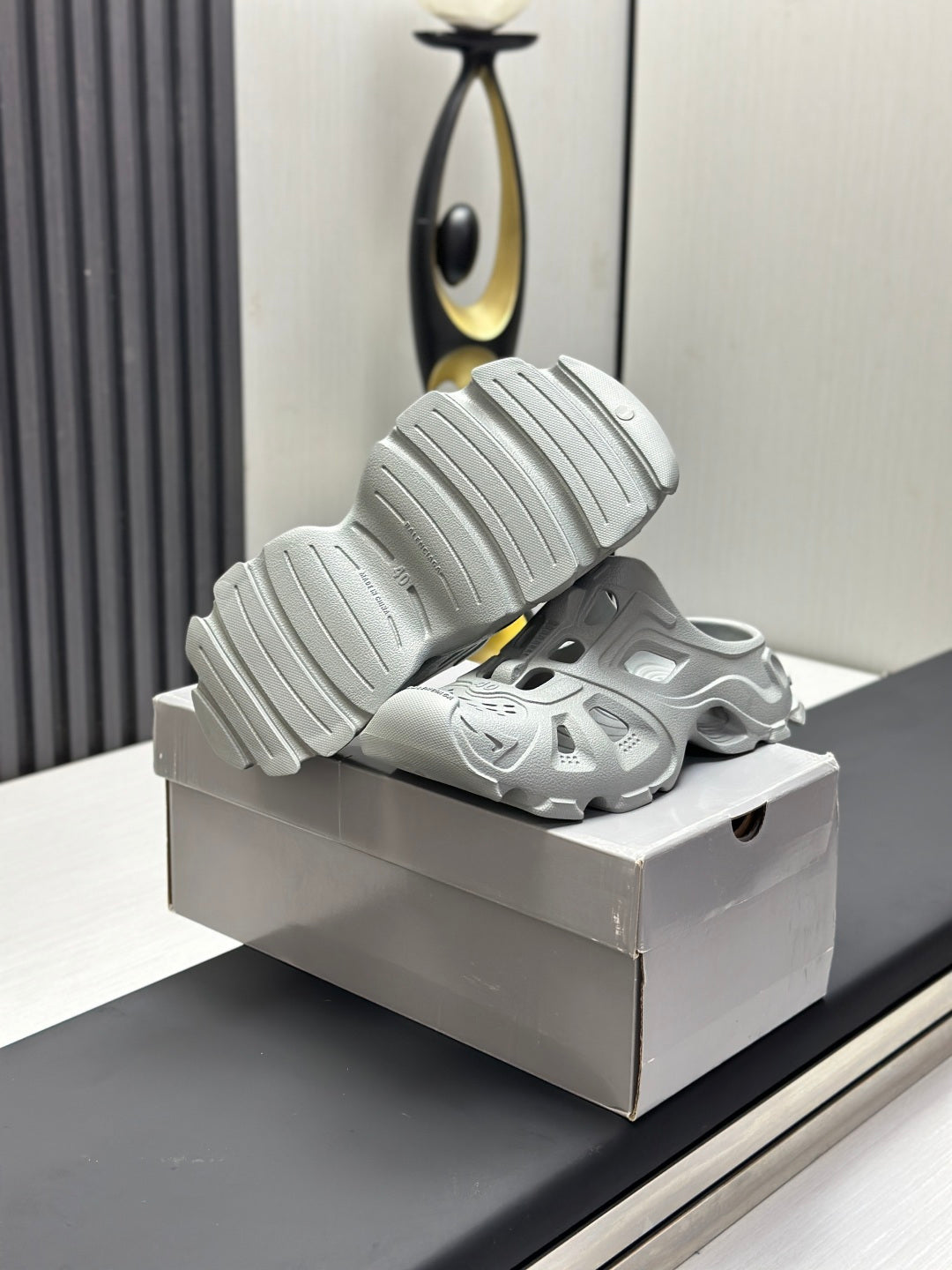 Balenciaga sandals, light gray, heel-up view showing ribbed sole treads