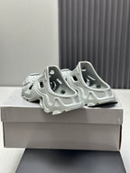 Balenciaga sandals, light gray, heel and side view with molded cutouts and straps