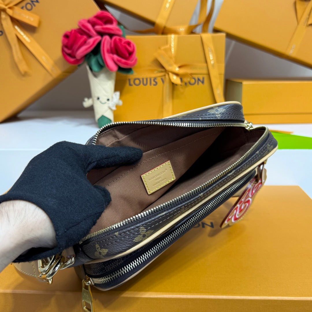 Louis Vuitton crossbody bag open with brown lining and label, viewed from above, monogram.