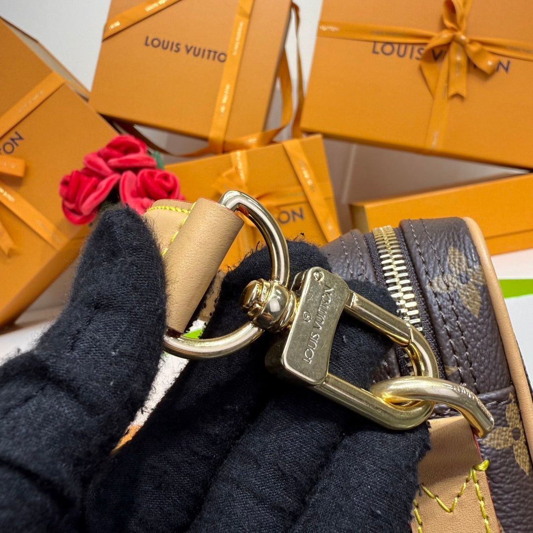 Louis Vuitton bag with gold ring hardware and leather strap, monogram canvas detail.