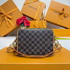 Monogram mini crossbody bag with checkered canvas front and gold-tone zippers.