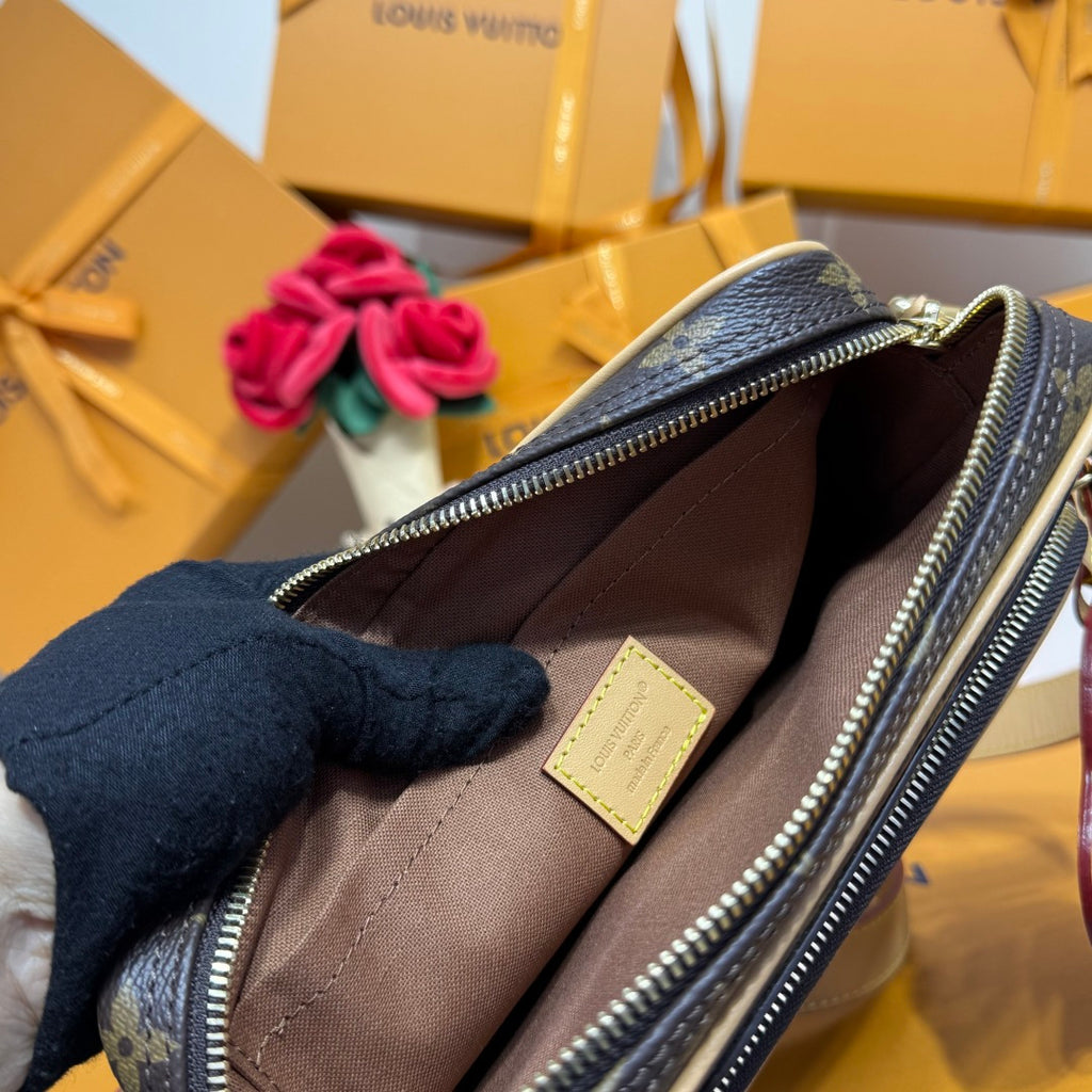 Monogram mini crossbody bag open interior with fabric lining and zip closure.