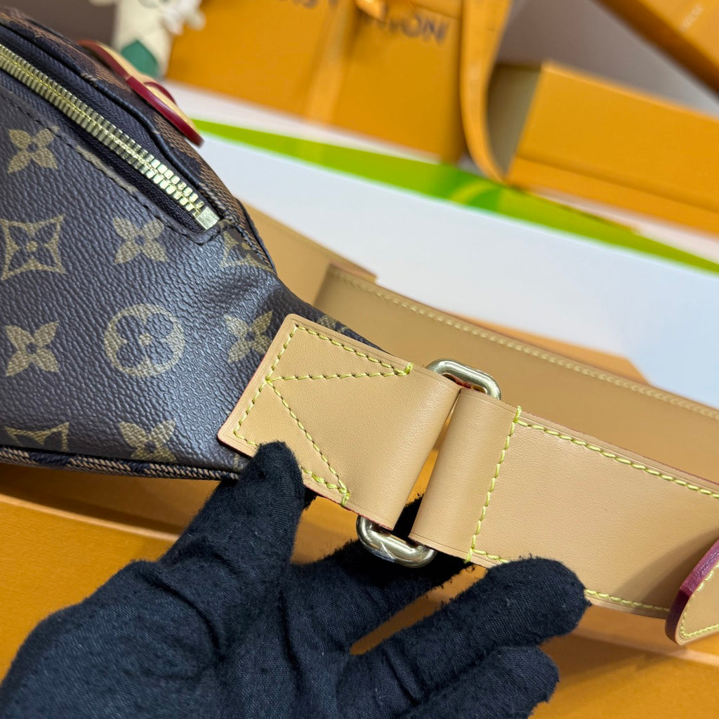Louis Vuitton monogram belt bag detail of beige strap buckle and stitched leather trim