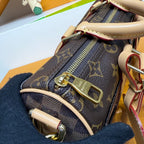 Louis Vuitton mini handbag close-up of zipper track and gold hardware on monogram canvas
