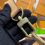 Monogram handbag keyring attachment with metal clasp and stitched leather detail