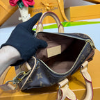 Louis Vuitton monogram canvas satchel with top zip, tan leather trim, open interior