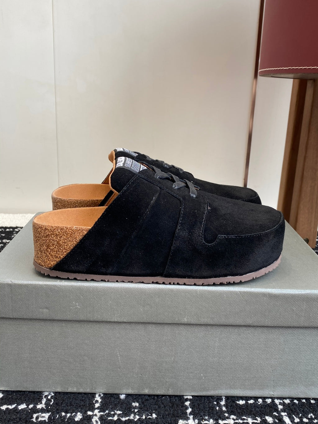 Black suede lace-up sneakers with tan lining and thick sole, side view