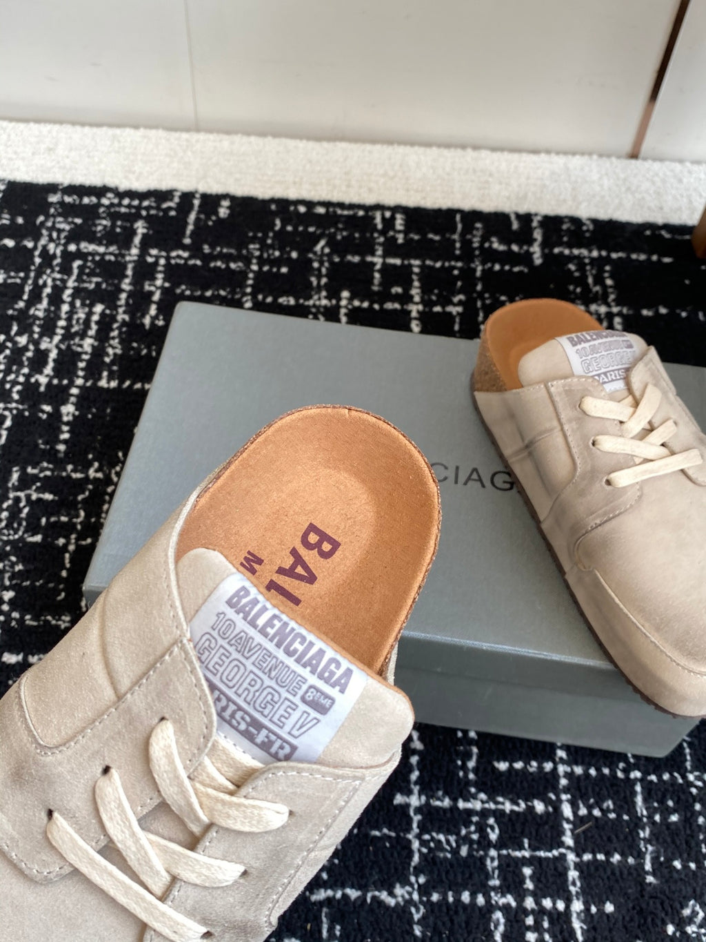 Light tan suede lace-up sneaker with logo insole, close-up on the shoe