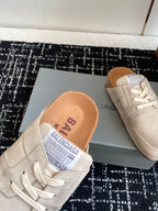 Light tan suede lace-up sneaker with logo insole, close-up on the shoe