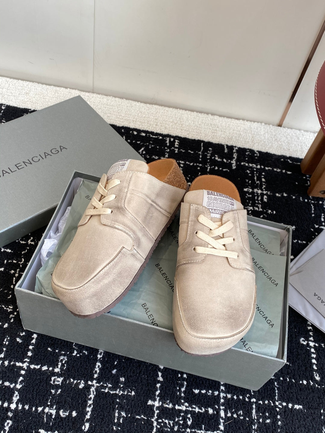 Light tan suede lace-up sneakers in a shoebox, front and side views