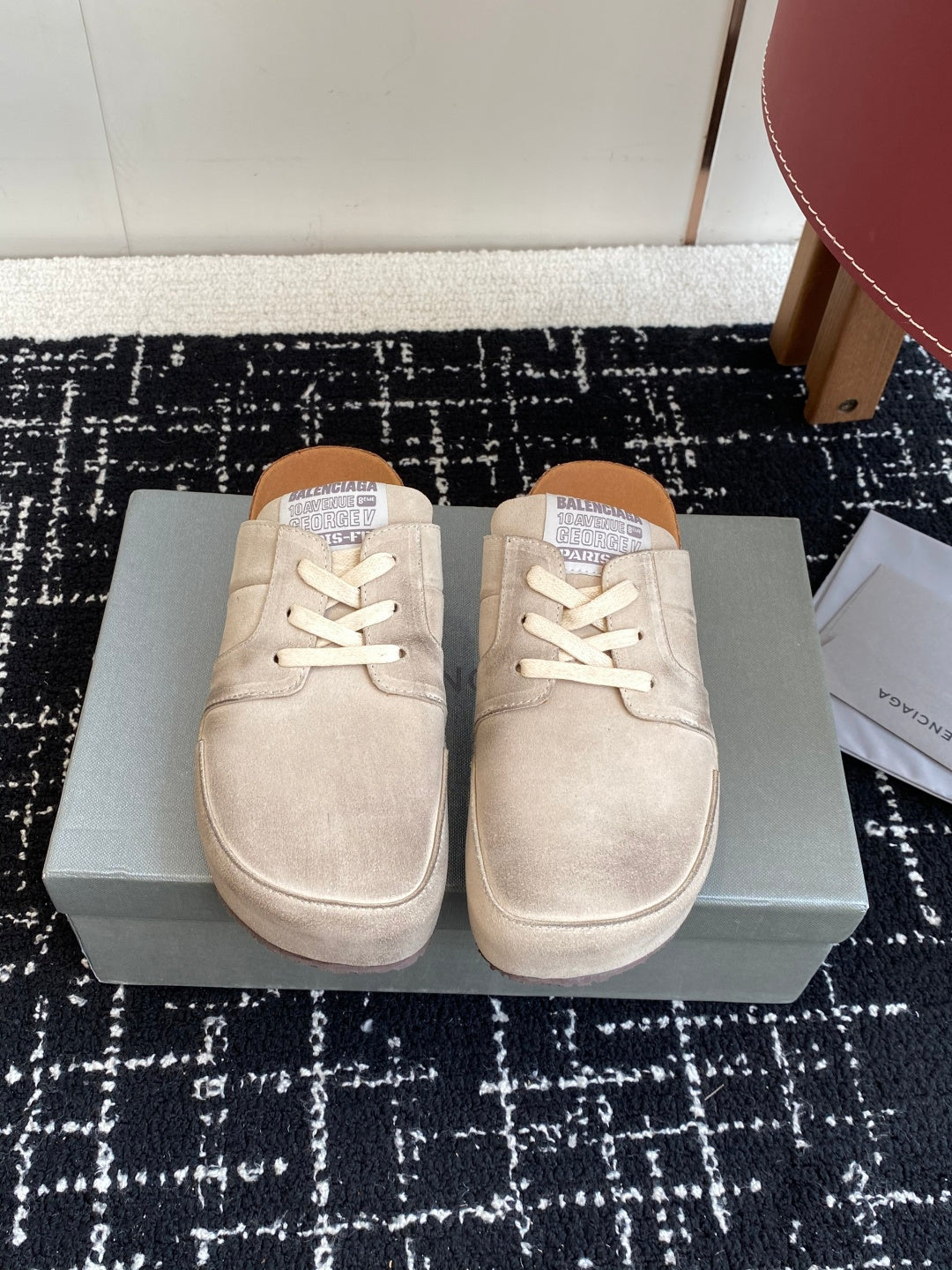 Pair of light tan lace-up sneakers, side view with white laces
