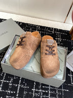 Balenciaga suede lace-up sandals in tan suede, two shoes on display