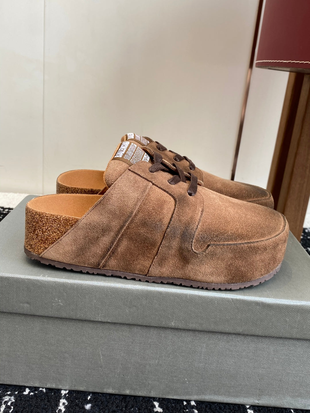Balenciaga suede lace-up sandals in tan, side view on foot