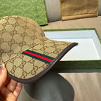 Tan GG baseball cap side view with multicolor Web stripe and black brim