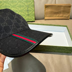 Black Gucci baseball cap with GG monogram and green-red web stripe across brim