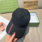 Black Gucci baseball cap with GG monogram and green-red web stripe along the side