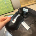 Black Gucci baseball cap close-up of adjustable strap and inner label
