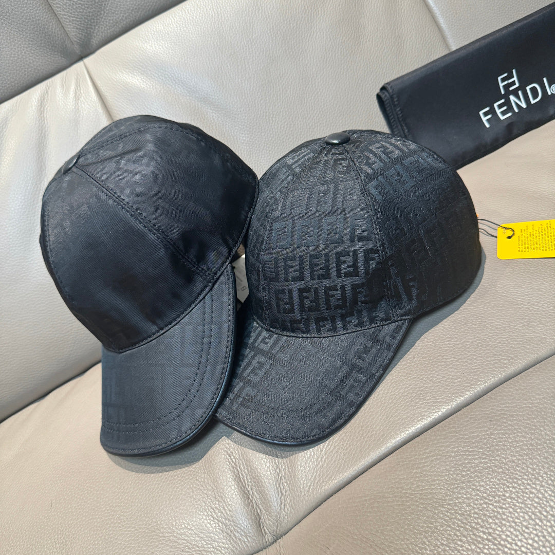 Fendi monogram baseball cap pair, dark patterned caps with curved brims and top panels.