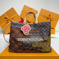 Louis Vuitton monogram tote bag with two-tone patchwork and top handles, front charm