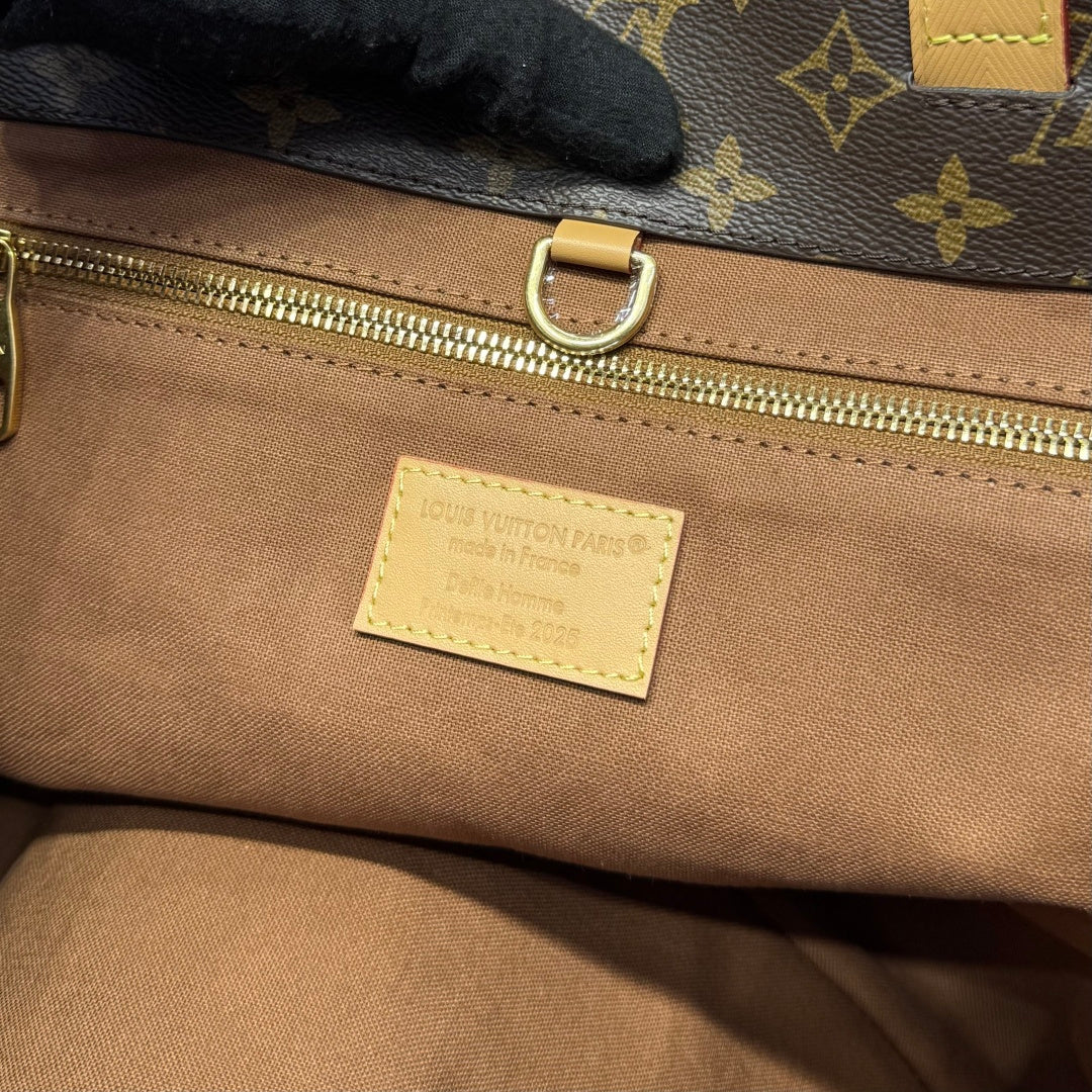 Louis Vuitton interior patch label on beige lining with gold zipper and monogram edge