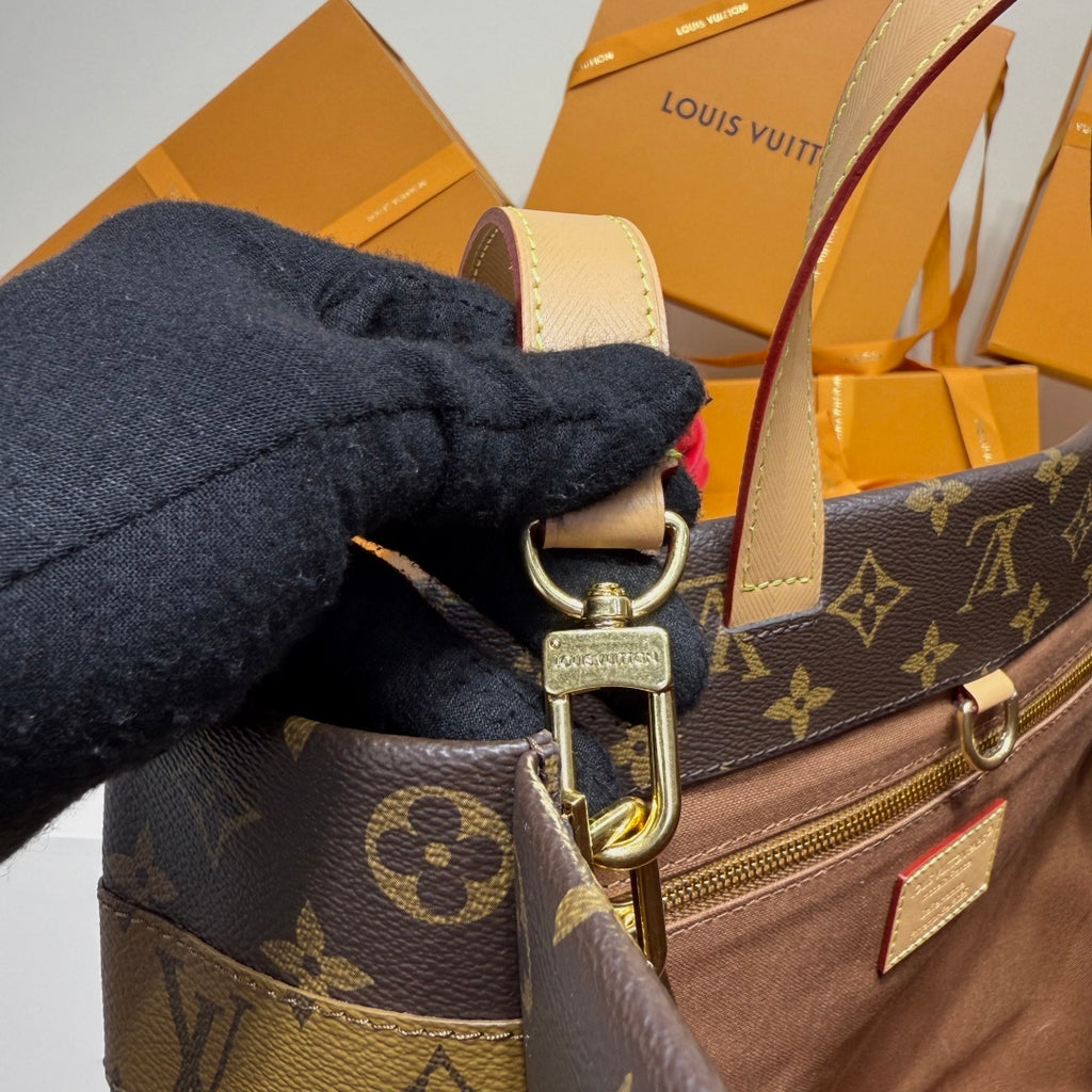 Louis Vuitton bag strap and D-ring hardware with monogram fabric and leather trim