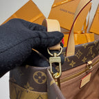 Louis Vuitton bag strap and D-ring hardware with monogram fabric and leather trim