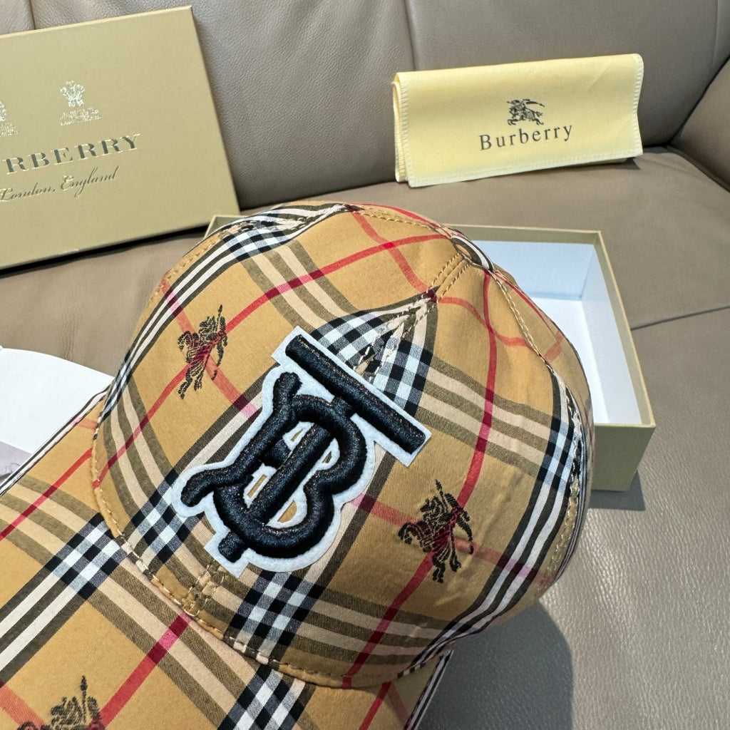 Plaid baseball cap front panel close-up with embroidered monogram and small horse motifs