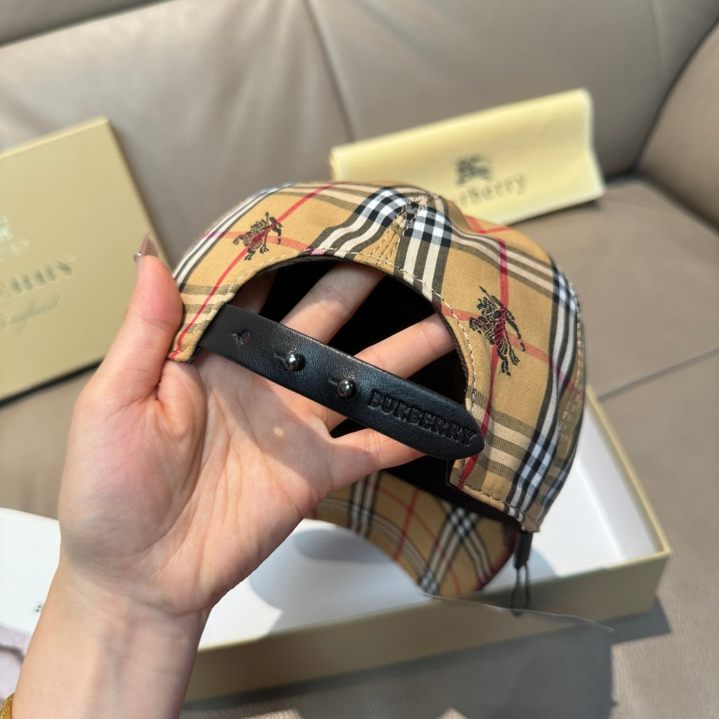 Plaid baseball cap brim detail showing dark underside and adjustable strap