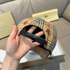 Plaid baseball cap brim detail showing dark underside and adjustable strap