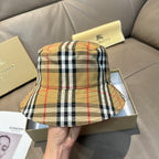 Plaid bucket hat with curved crown and beige black red check pattern.