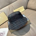 Burberry plaid bucket hat in dark navy with red and gray tartan lines, curved brim
