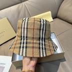 Burberry plaid bucket hat with wide brim, beige base with black and red lines