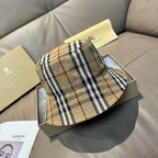 Burberry plaid bucket hat in beige with black and red stripes, stitched brim