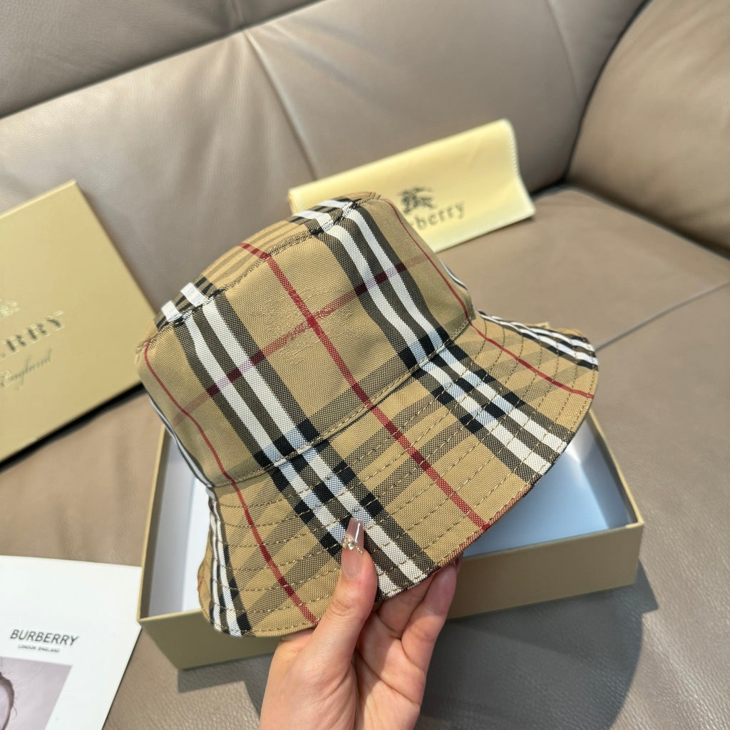 Burberry plaid bucket hat, beige with black and red stripes, angled close-up