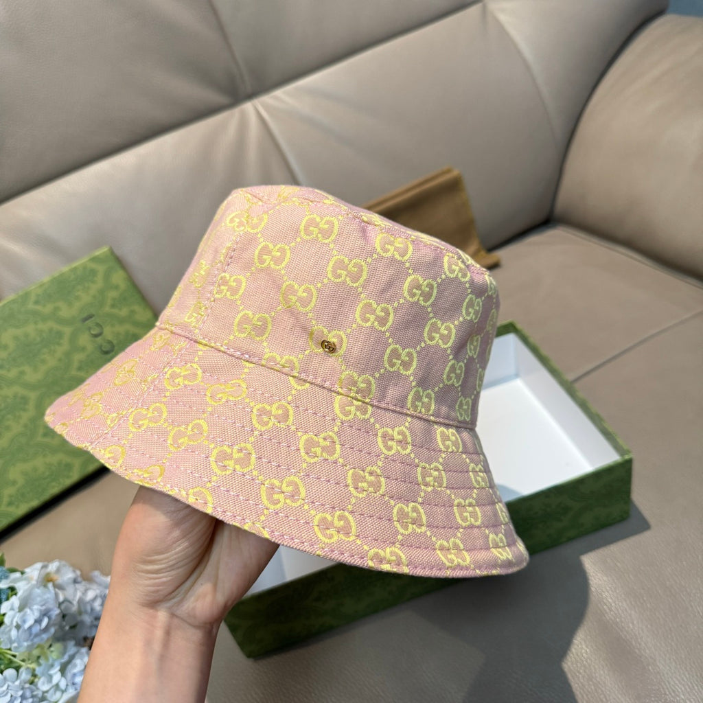 Gucci bucket hat on display, light pink with green GG motif and front button